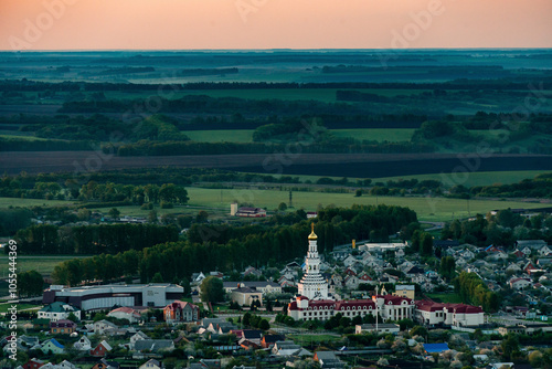 Aerial view of the beautiful village with historic church and expansive fields at sunset, Prokhorovka, Belgorod Oblast, Russia. photo