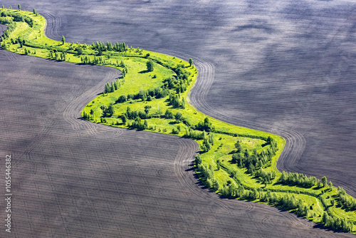 Aerial view of meandering river through lush green fields and tranquil trees, Lipetsk Oblast, Russia. photo