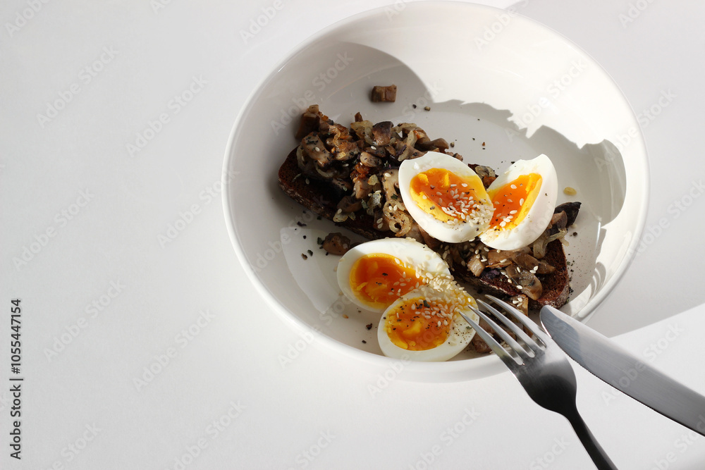 Eating Breakfast. Soft Boiled Eggs Served on Rye Toast with Fried Forest Mushrooms. Lunch, Brunch. Eating Breakfast. Soft Boiled Eggs Served on Rye Toast with Fried Forest Mushrooms. Lunch, Brunch.
