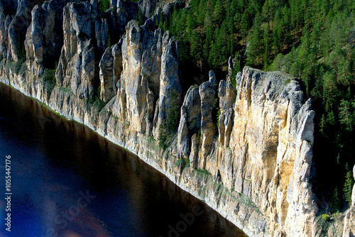 Aerial view of majestic lena pillars and rugged cliffs surrounded by serene forest and river, Lena Pillars National Park, Yakutia Republic, Russia. photo