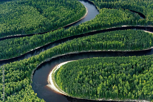 Aerial view of winding river through lush siberian taiga forest, khanty mansi autonomous okrug, russia.