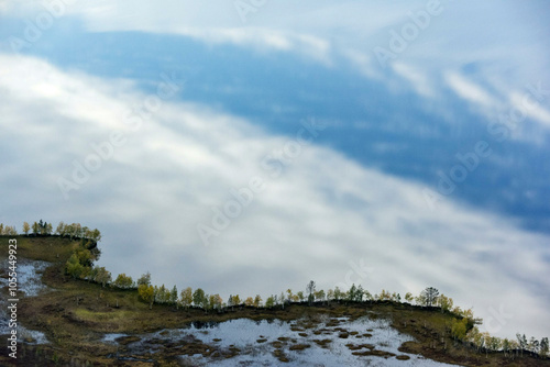 Aerial view of serene Numto Lake surrounded by trees and clouds, Khanty Mansi Autonomous Okrug, Russia.