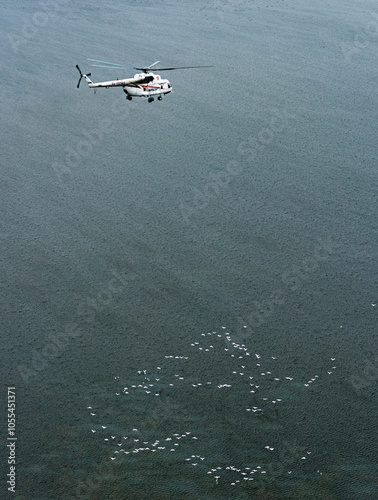 Russia - 10 November 2017: Aerial view of a beautiful helicopter flying over the calm and serene Caspian Sea, Russia. photo