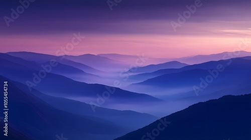 A misty mountain range at dusk with deep blue and purple hues in the sky