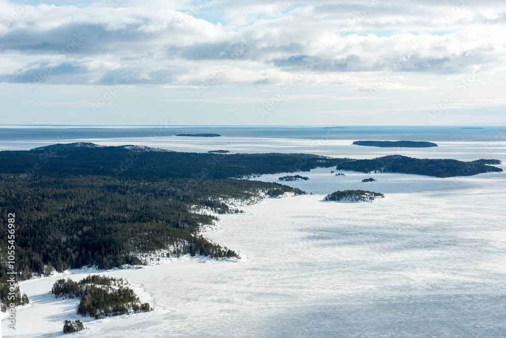 Aerial view of frozen Lake Ladoga surrounded by pristine snow-covered forests and islands, Karelia Republic, Russia. Aerial view of frozen Lake Ladoga surrounded by pristine snow-covered forests and islands, Karelia Republic, Russia.