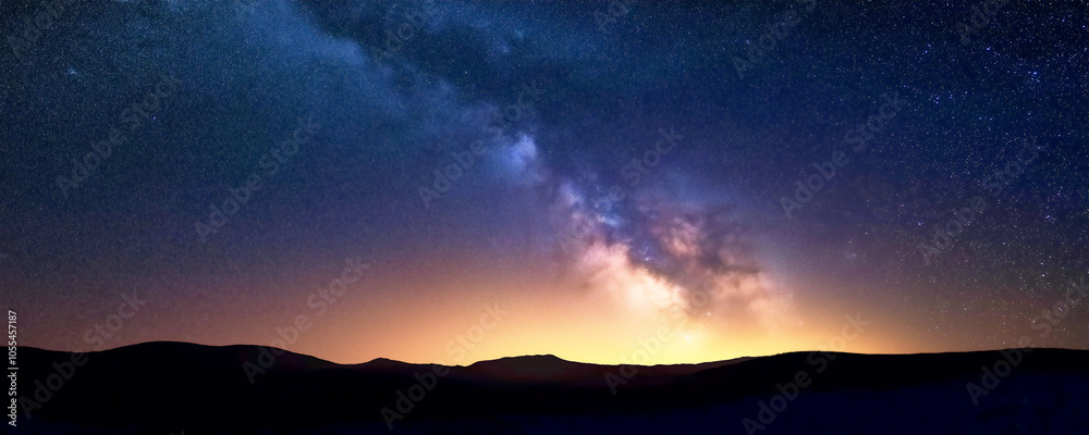 Starry sky over mountains at night, Milky Way galaxy visible in the distance, dark blue and white color scheme Starry sky over mountains at night, Milky Way galaxy visible in the distance, dark blue and white color scheme
