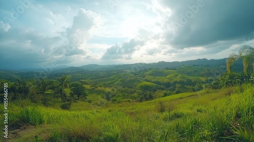 Lush green hills and mountains with a bright blue sky and white clouds.