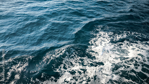 sea water with waves, white foam and reflection texture background