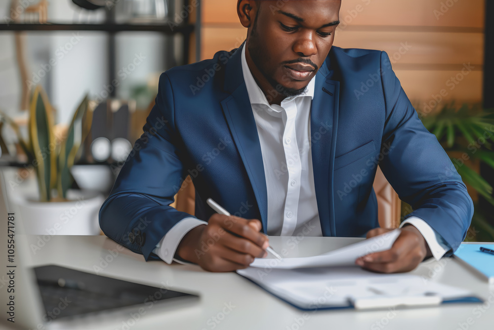 A businessman writing on paper is sitting on the desk. A businessman writing on paper is sitting on the desk.