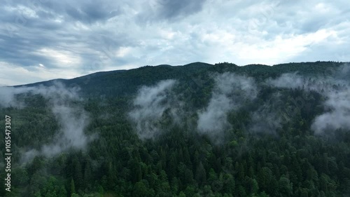 Drone flight over mountains in thick fog. Mavic 3