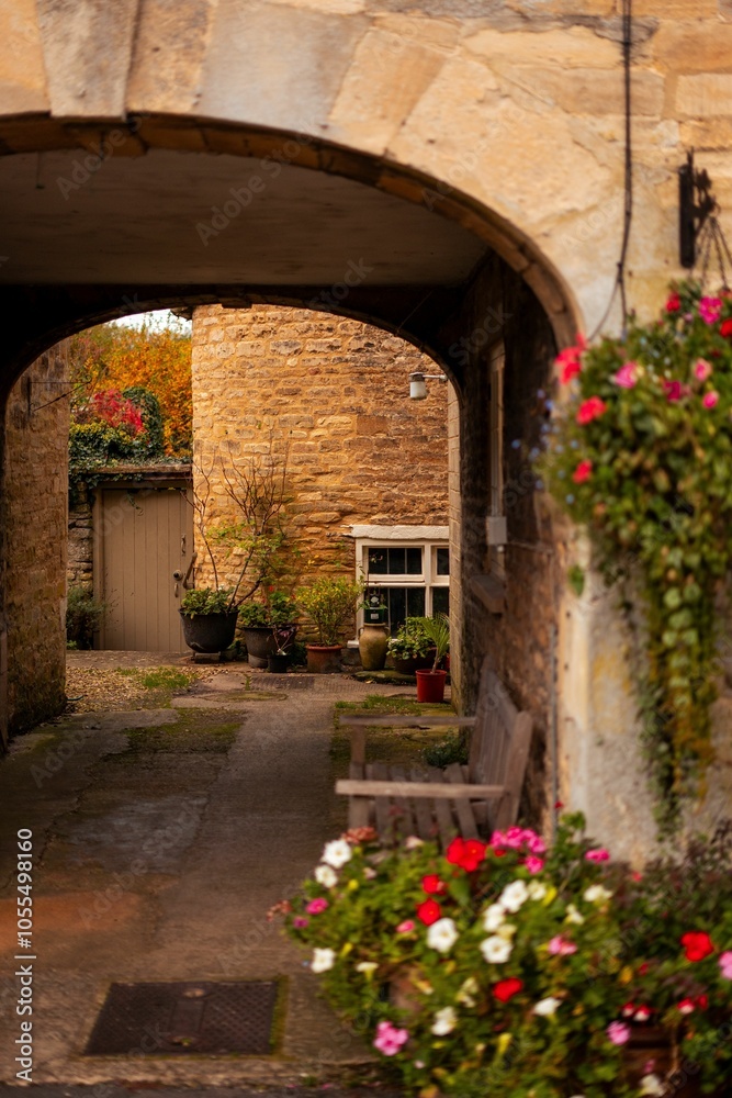 Obraz premium Charming stone archway to a quaint courtyard.