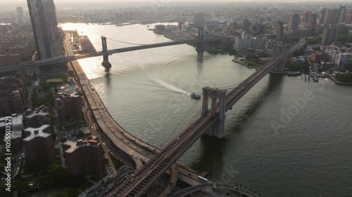 Aerial view of brooklyn bridge spanning the east river with a beautiful skyline and busy streets, new york, united states.