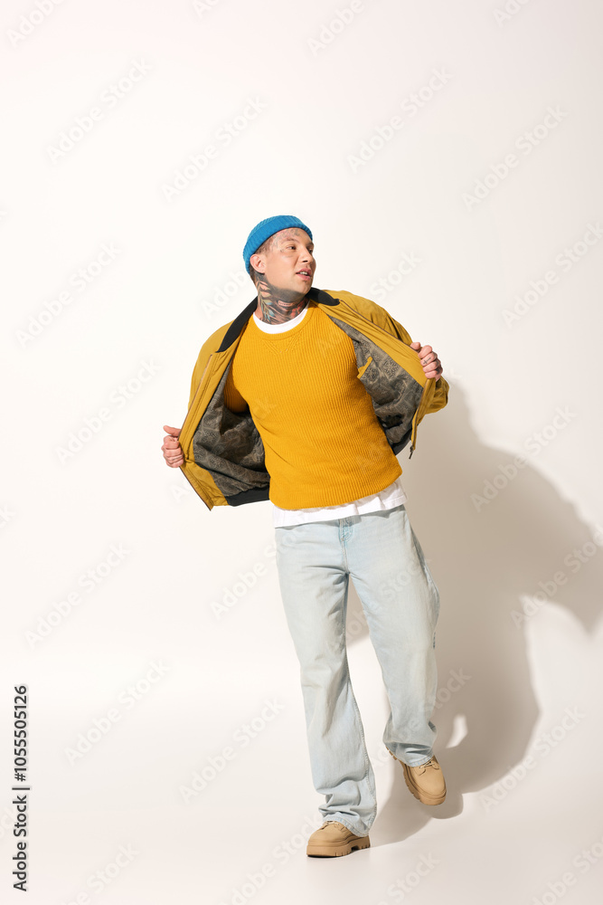 A young man confidently poses in a stylish outfit, highlighting his tattoos and vibrant colors. A young man confidently poses in a stylish outfit, highlighting his tattoos and vibrant colors.