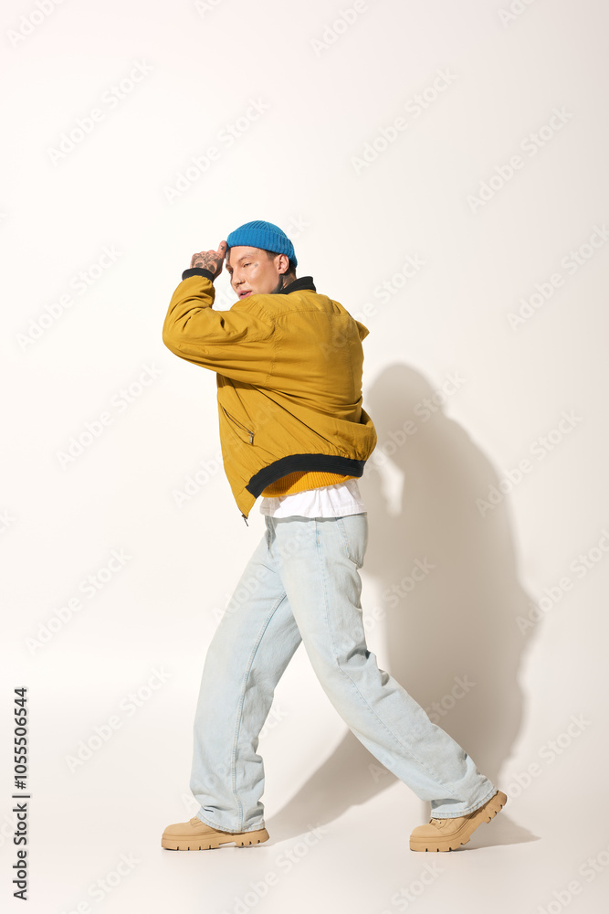 The young man showcases his unique tattoos while striking a vibrant pose in relaxed clothing. The young man showcases his unique tattoos while striking a vibrant pose in relaxed clothing.
