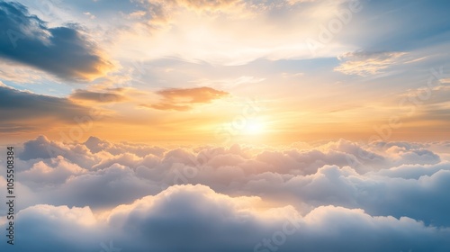  The sun rises above clouds, shining through with a blue, yellow, and white sky