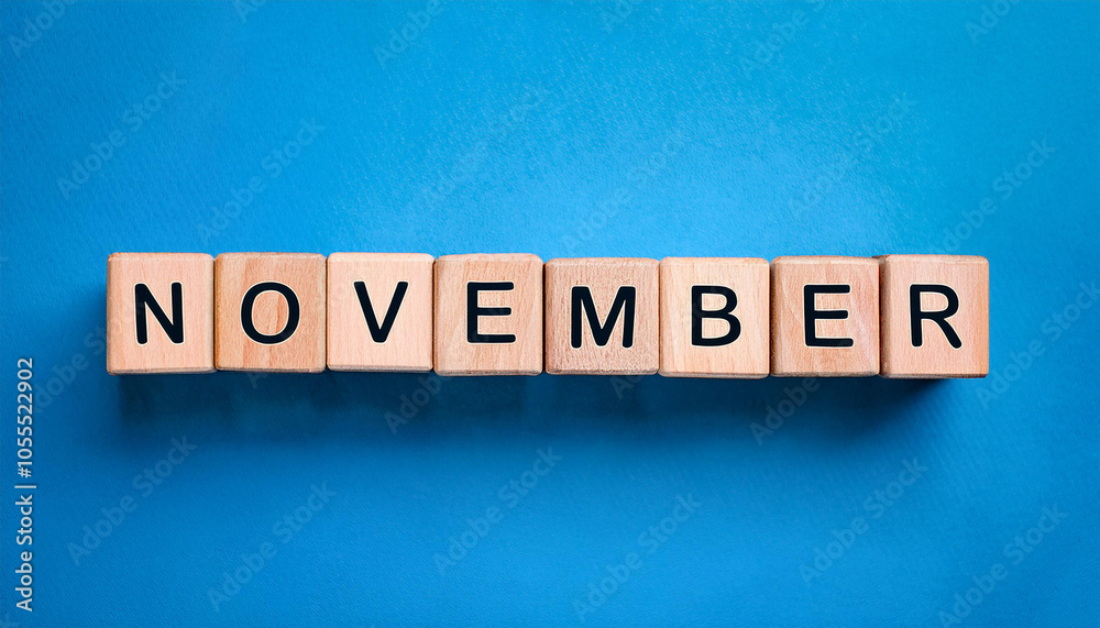 Wooden cubes with text NOVEMBER on blue backdrop. Autumn season. Month of year. Wood block Wooden cubes with text NOVEMBER on blue backdrop. Autumn season. Month of year. Wood block