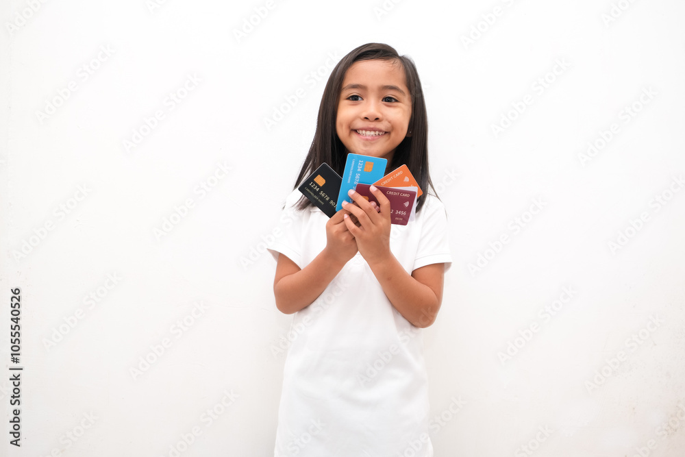 portrait of little girl holding credit card isolated white background portrait of little girl holding credit card isolated white background