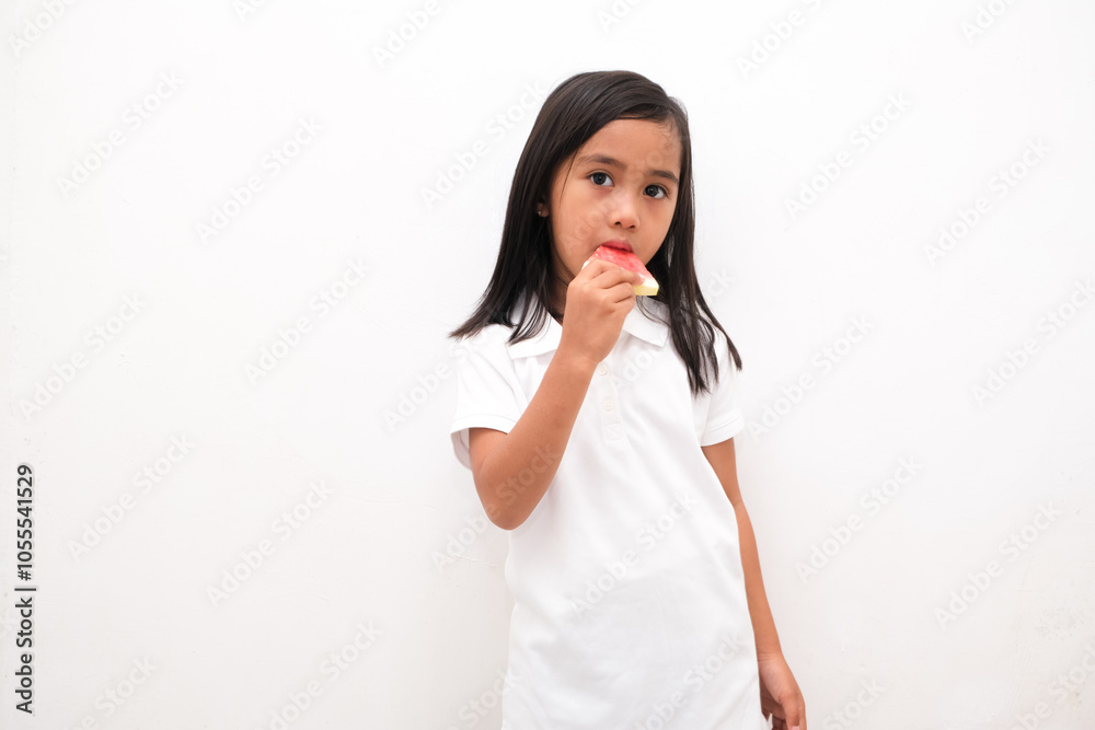 Cute little Asian girl enjoying watermelon isolated on white background