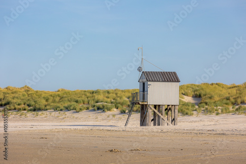 A wooden shelter on high stilts that stands on the North Sea beach (De Drenkelingenhuisje) The Dutch Wadden Sea island Terschelling, Municipality and an island in the northern, Friesland, Netherlands. photo