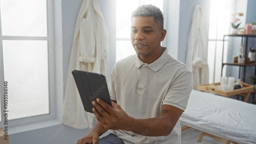 Young man taking a selfie with a tablet in a rehab clinic room, capturing a casual moment indoors with a confident expression in a healthcare setting. Young man taking a selfie with a tablet in a rehab clinic room, capturing a casual moment indoors with a confident expression in a healthcare setting.
