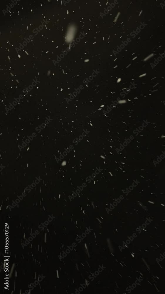 Abstract snowfall on black background, winter, falling snow.