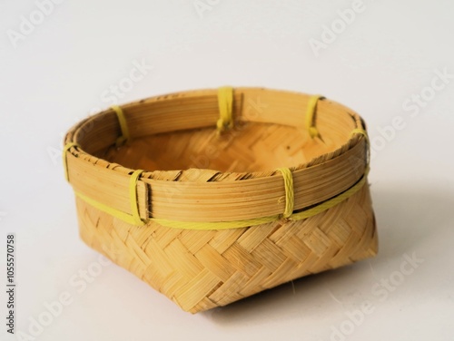 Indonesian traditional besek or a food container made of woven bamboo isolated white background. DIY  food container usually used for traditional event photo