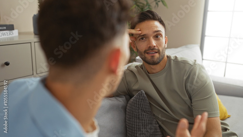 Couple of gay men spending time together in a cozy living room, sharing a relaxed and intimate moment.