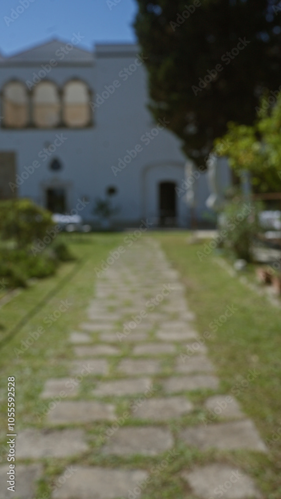 Pathway leading to historic building in puglia, italy with greenery on both sides during a sunny day, showcasing european architecture and serene outdoor setting Pathway leading to historic building in puglia, italy with greenery on both sides during a sunny day, showcasing european architecture and serene outdoor setting