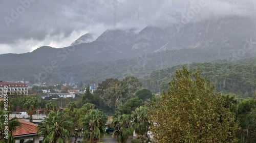 View from the balcony of the hotel on the fog, mountains. Morning or evening cloudy sky with heavy rain