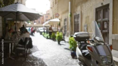 Blurry street scene in rome with people dining under umbrellas on a cobblestone path and a scooter parked nearby against a backdrop of historic architecture.