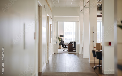 White hallway with wooden floor leading to a modern office with a black chair and a wooden desk Minimalist design clean and professional corporate success 