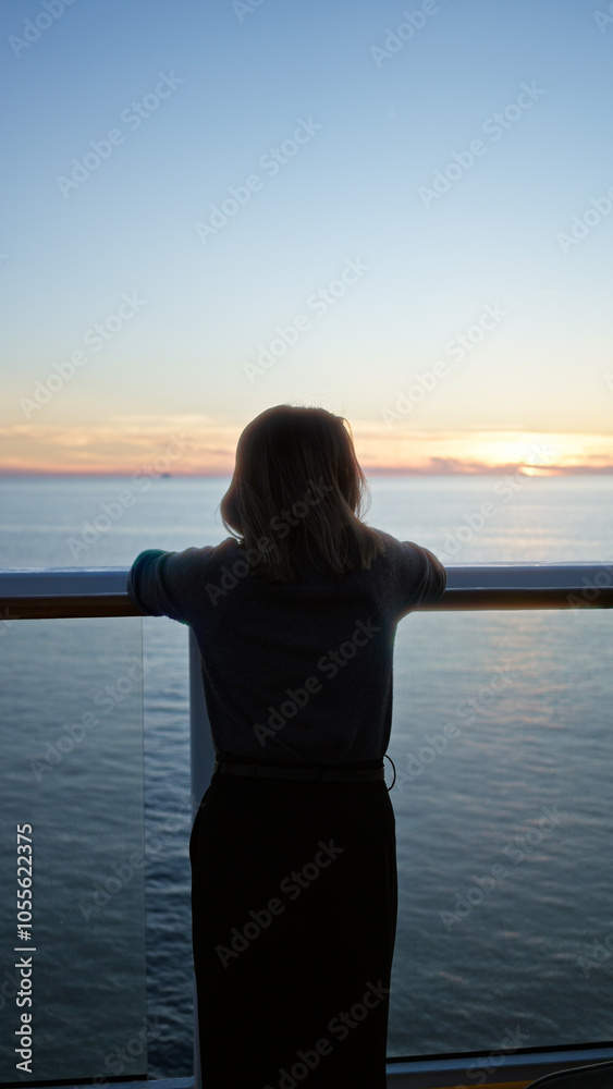 Fototapeta premium Woman standing on cruise ship at sunset overlooking ocean horizon embracing tranquility and adventure displaying youthful beauty and serenity outdoors on dock