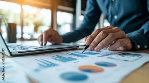 Businessman analyzing data charts with laptop