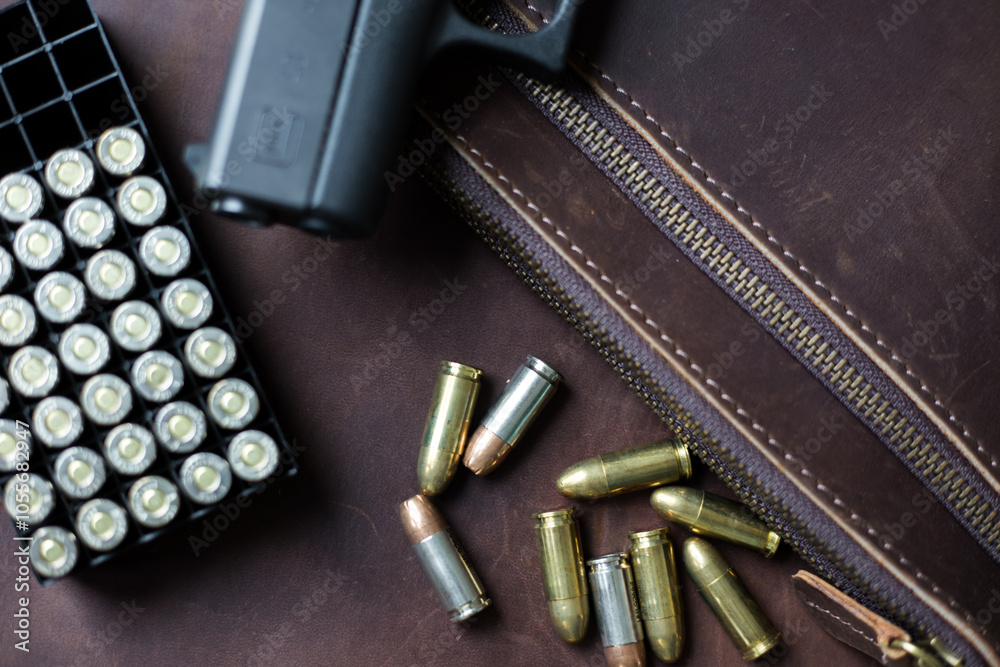 9mm Sub compact everday carry modern gun with bullet on leather background