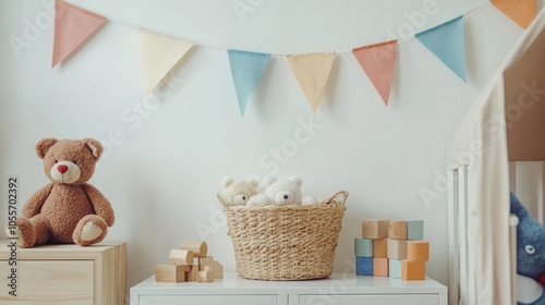 Stylish and modern child room with hanging cotton colorful flags on the white wall, boxes, teddy bear in natural basket, toys and wooden accessories
