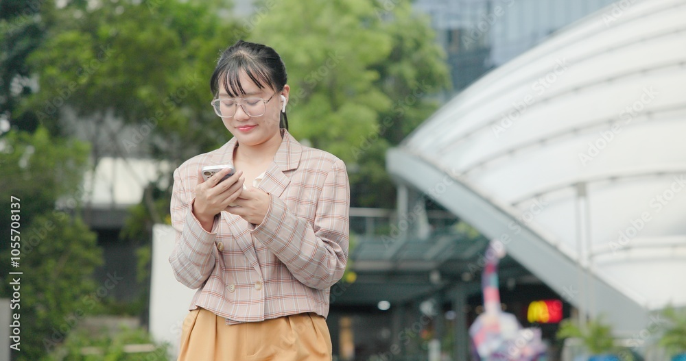 Fototapeta premium Asian teenage woman using smartphone to shop online. Women make financial transactions, transfer money via bank apps, order products. Businesswoman chatting on mobile phone. communication technology