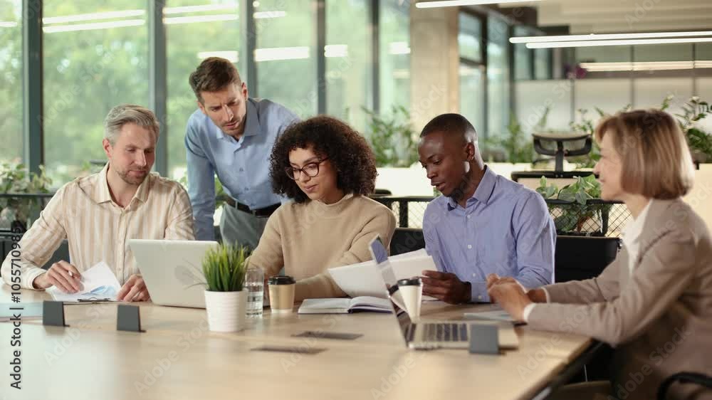 Business people working together on project using laptop in modern office Business people working together on project using laptop in modern office