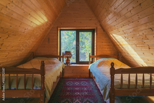 Interior of a country house bedroom with beds and wood paneled walls