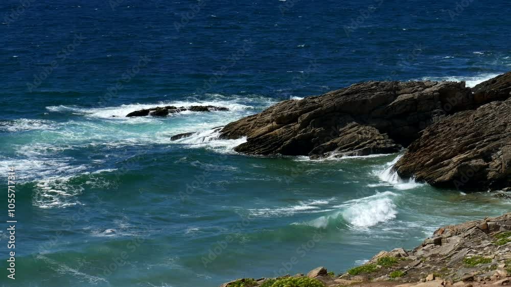 Waves crash against rocks in a sunny day. Power of nature. Super Slow motion 4K Waves crash against rocks in a sunny day. Power of nature. Super Slow motion 4K