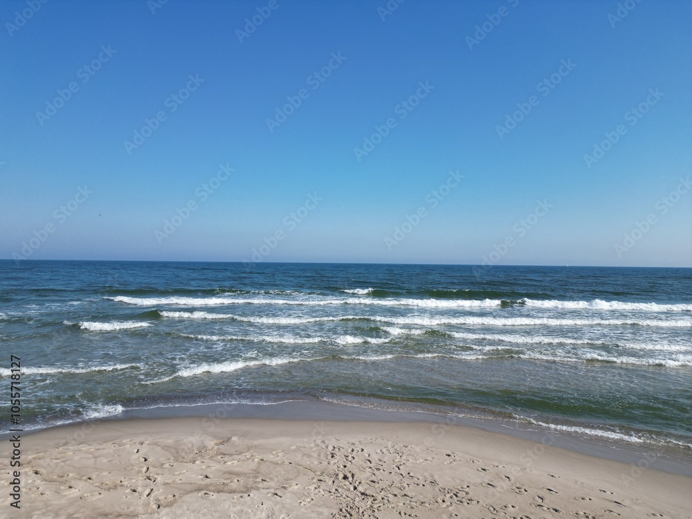 Serene Beach with Gentle Waves and Clear Blue Sky Serene Beach with Gentle Waves and Clear Blue Sky