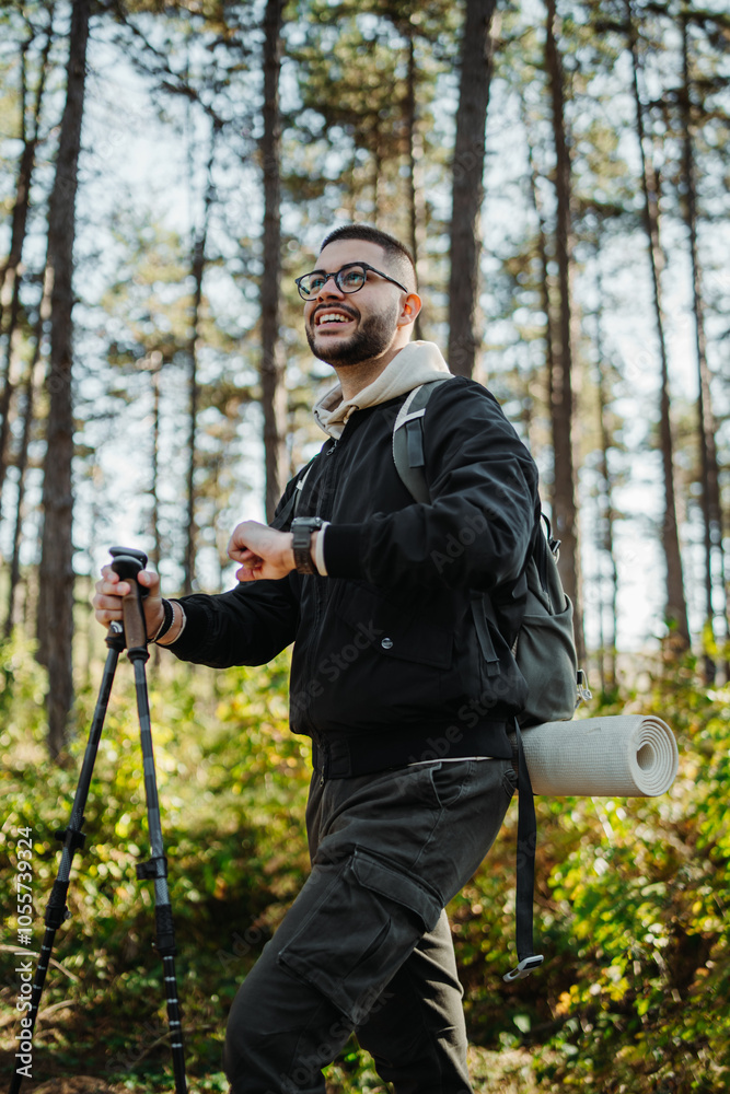 Young caucasian man hiking or trekking through the forest Young caucasian man hiking or trekking through the forest