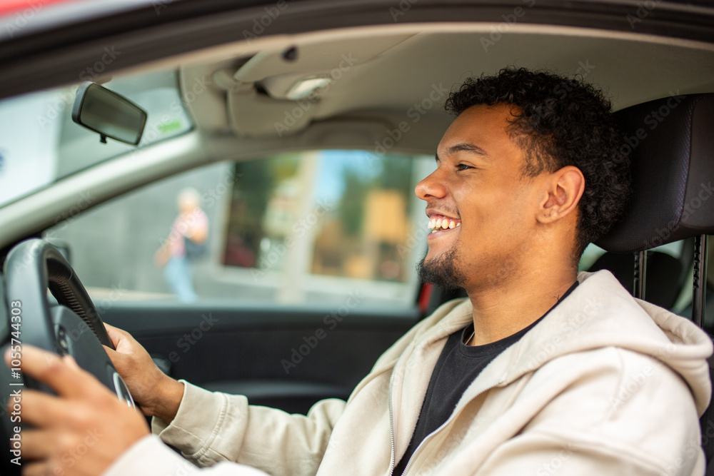 Man smiling while sitting in the car in the city Man smiling while sitting in the car in the city