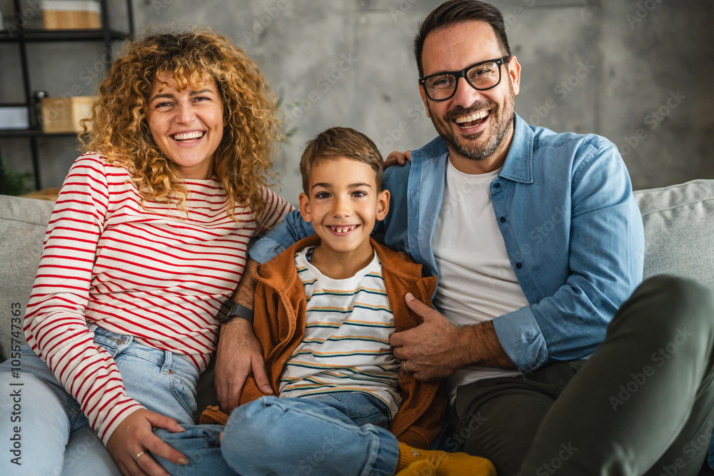 portrait of mother, father and son while sit on sofa together portrait of mother, father and son while sit on sofa together