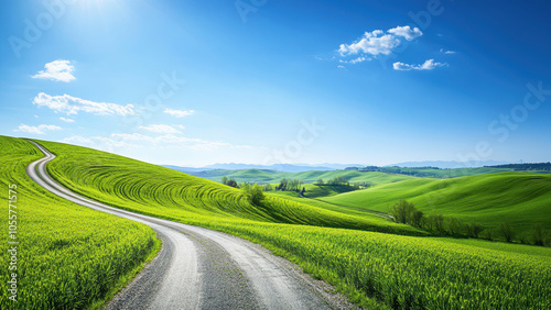 Winding road leading through rolling green hills under a blue sky with fluffy clouds.