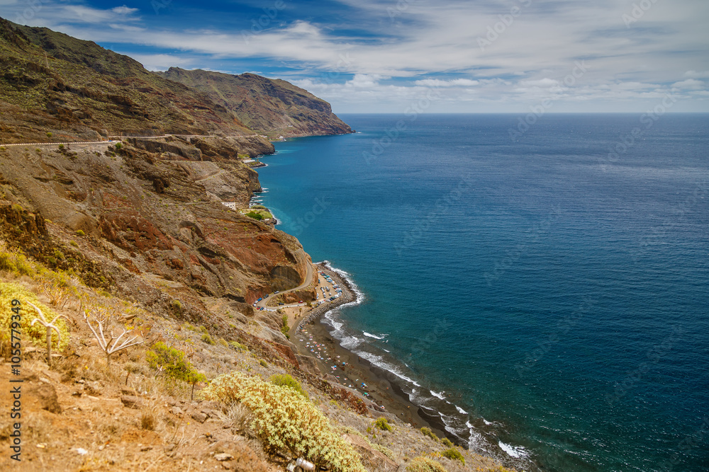 Aerial view of Tenerife’s Playa de las Gaviotas displaying striking contrasts with dark sands, rocky cliffs, and a turquoise ocean Aerial view of Tenerife’s Playa de las Gaviotas displaying striking contrasts with dark sands, rocky cliffs, and a turquoise ocean