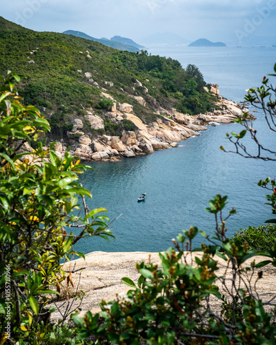 View of serene coastline with rocks and lush greenery, Cheung Chau, Hong Kong. photo