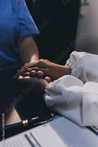 Kind male doctor wearing white coat consulting elder senior female patient holding hand of older woman giving help, safety, empathy and support, showing care and compassion concept. Close up view