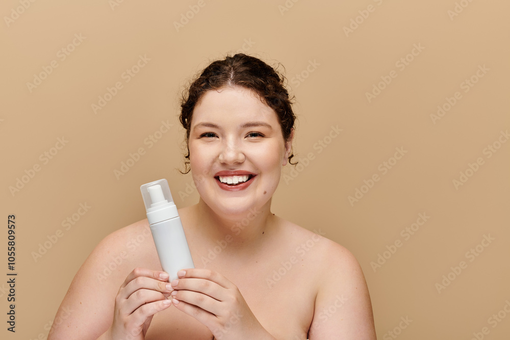 A beautiful woman smiles brightly while holding a skincare bottle in a soft, neutral backdrop. A beautiful woman smiles brightly while holding a skincare bottle in a soft, neutral backdrop.