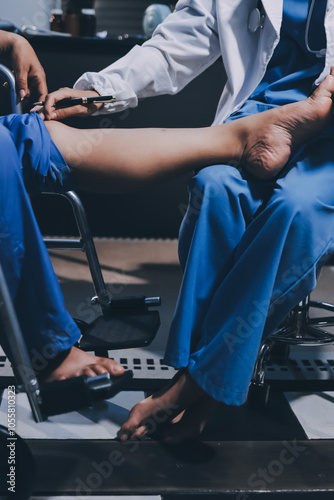 Physiotherapist nurse doing physiotherapy to rehabilitate leg of elderly female patient.