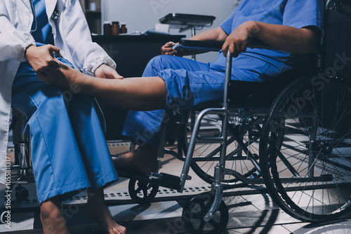 Physiotherapist nurse doing physiotherapy to rehabilitate leg of elderly female patient.